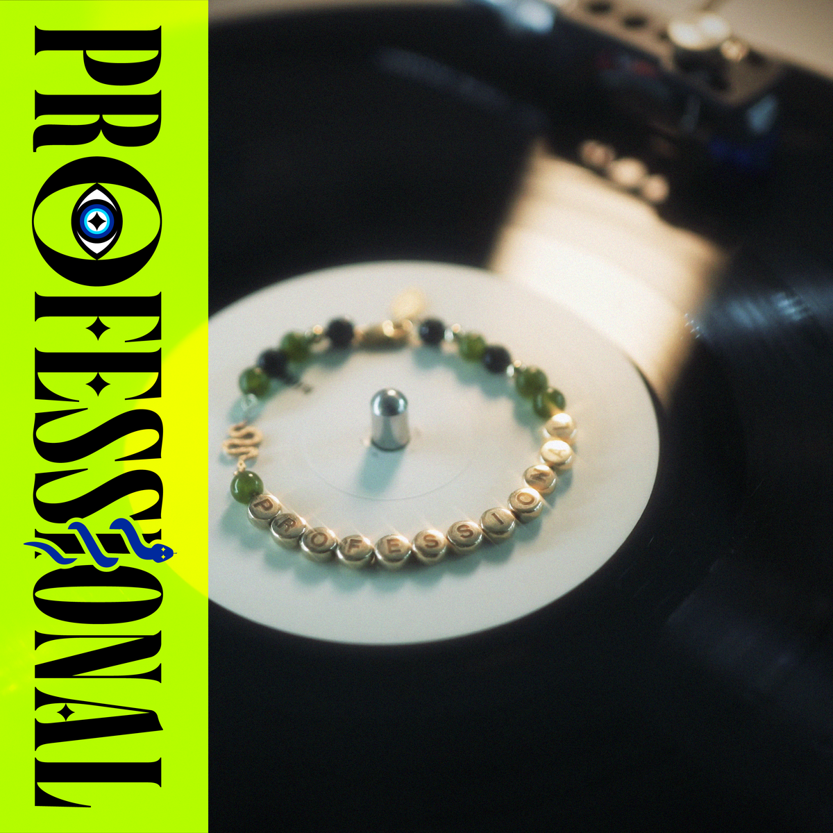 A gold friendship bracelet reading "PROFESSIONAL" sits on the white centre label of a record. A wordmark with the title contains an evil eye inside the 'O', and a snake wrapped around the 'I'