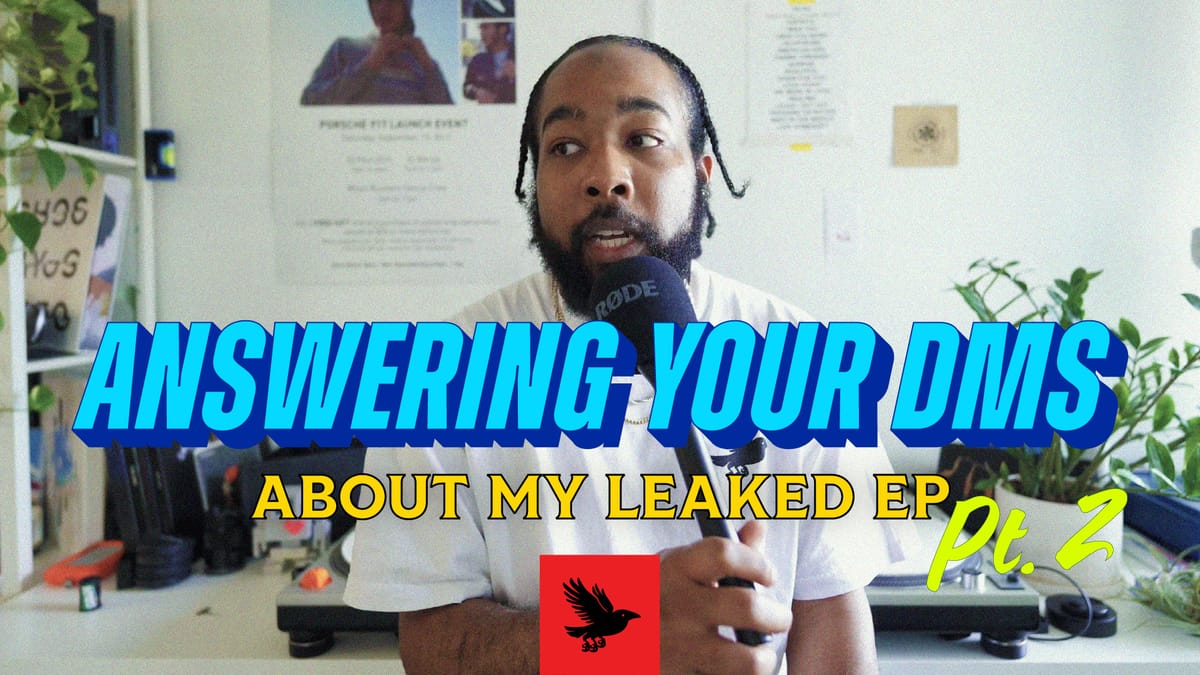 Paul is wearing a white t-shirt, and holding a microphone. His hair is braided. The title graphic for Answering Your DMs is set in front of him.