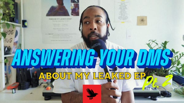 Paul is wearing a white t-shirt, and holding a microphone. His hair is braided. The title graphic for Answering Your DMs is set in front of him.